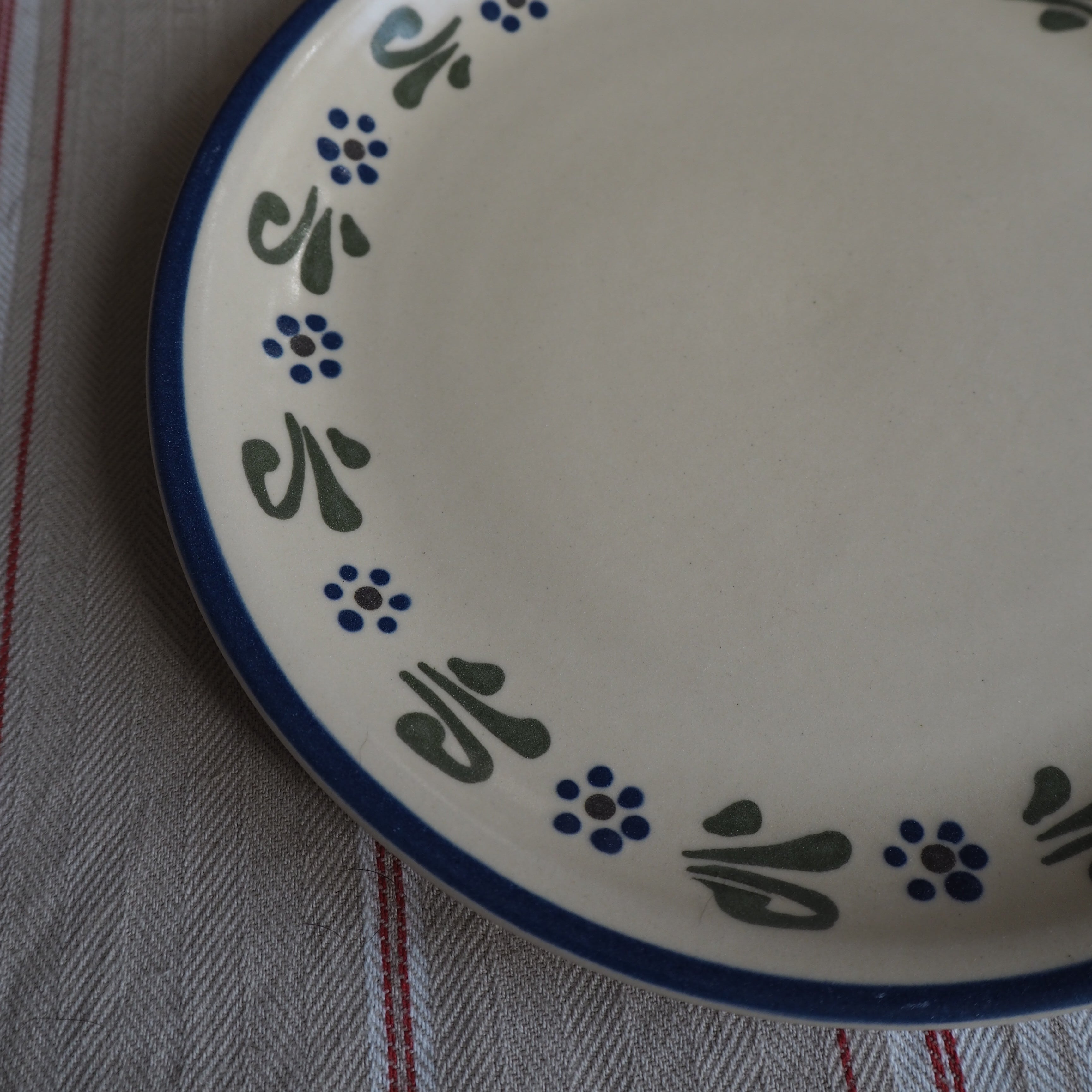 Cremefarvet frokosttallerken m. blå/grønne blomster